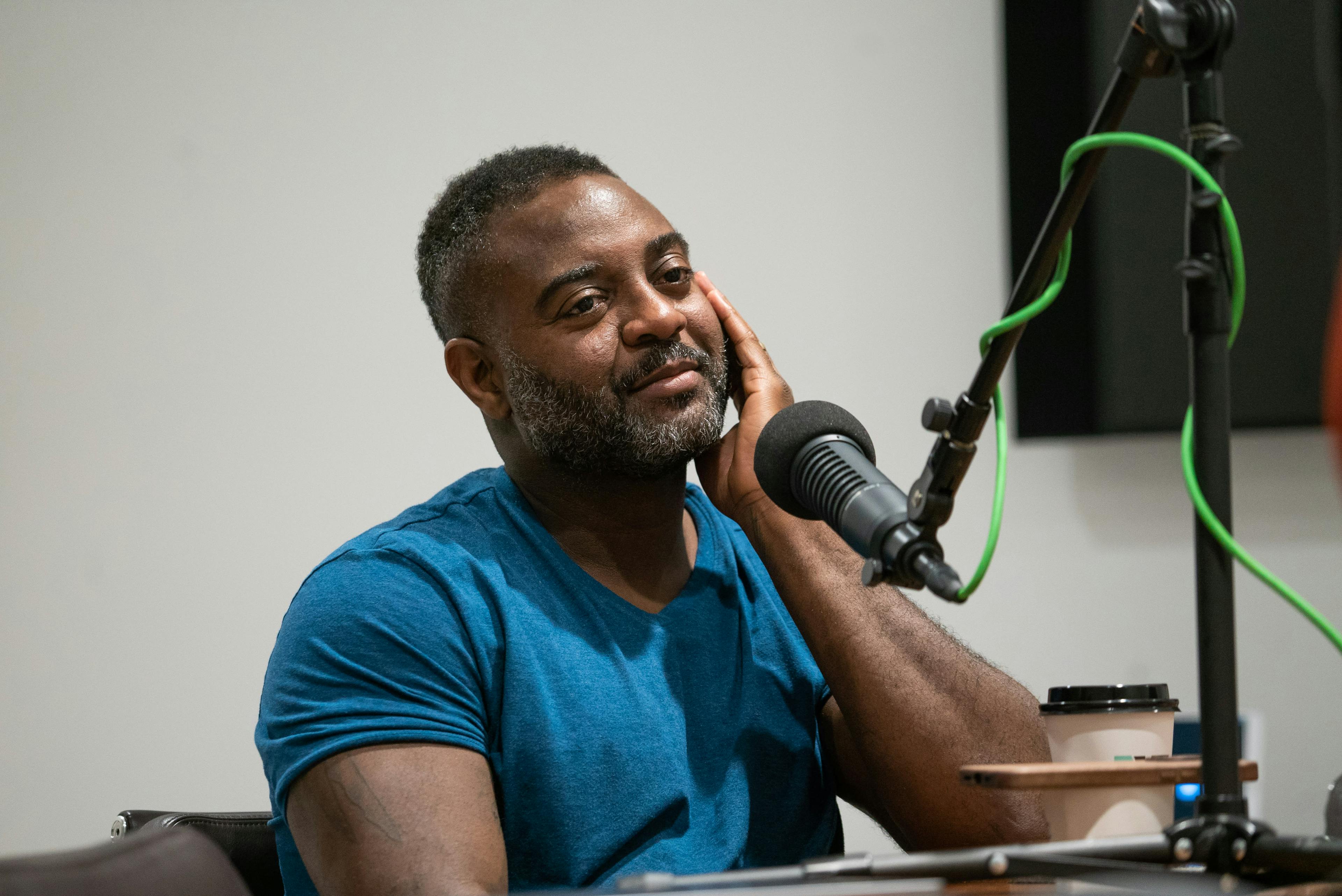 Dwayne Betts in a studio behind a microphone.