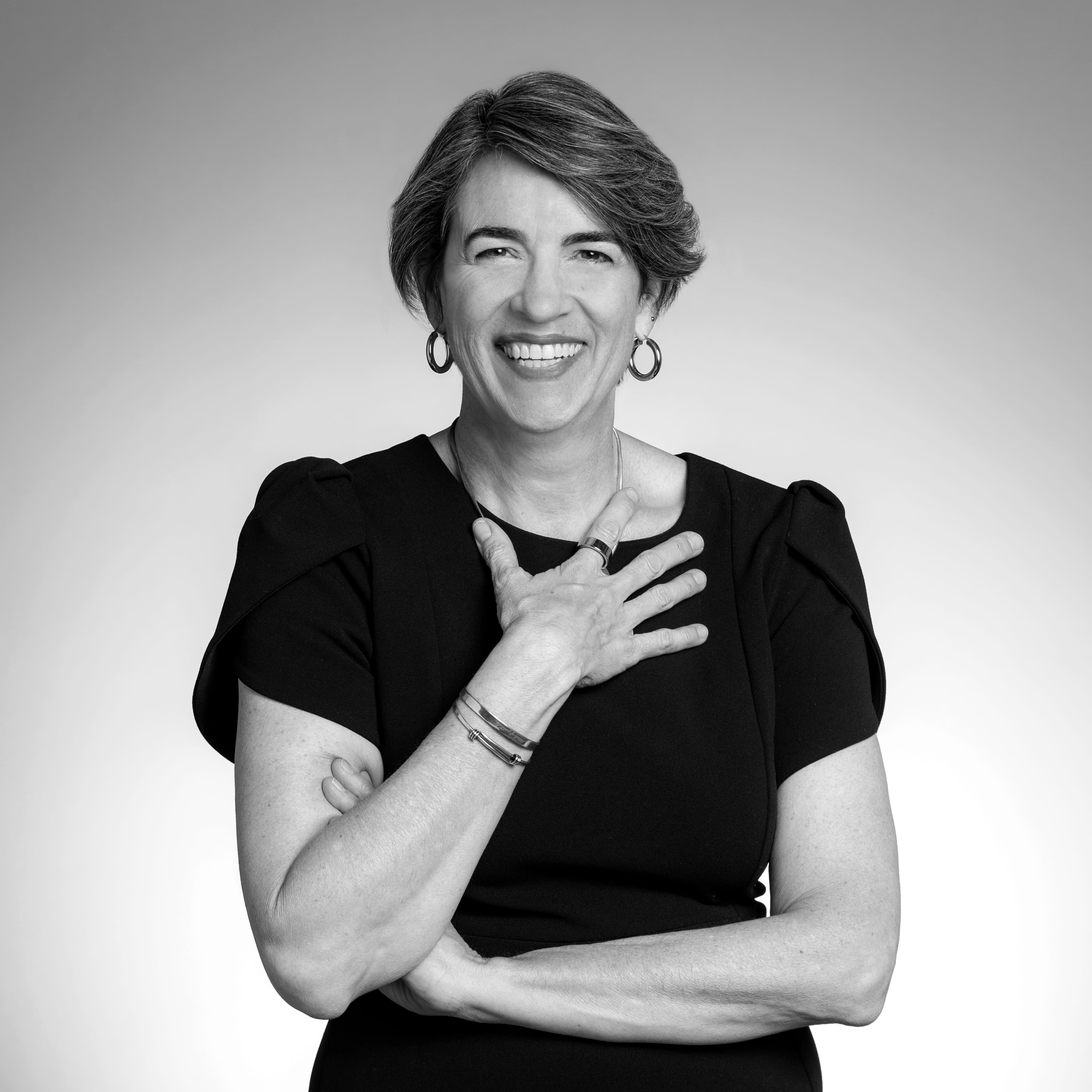 Picture of Anne Marie Burgoyne in black and white holding her hand on her chest