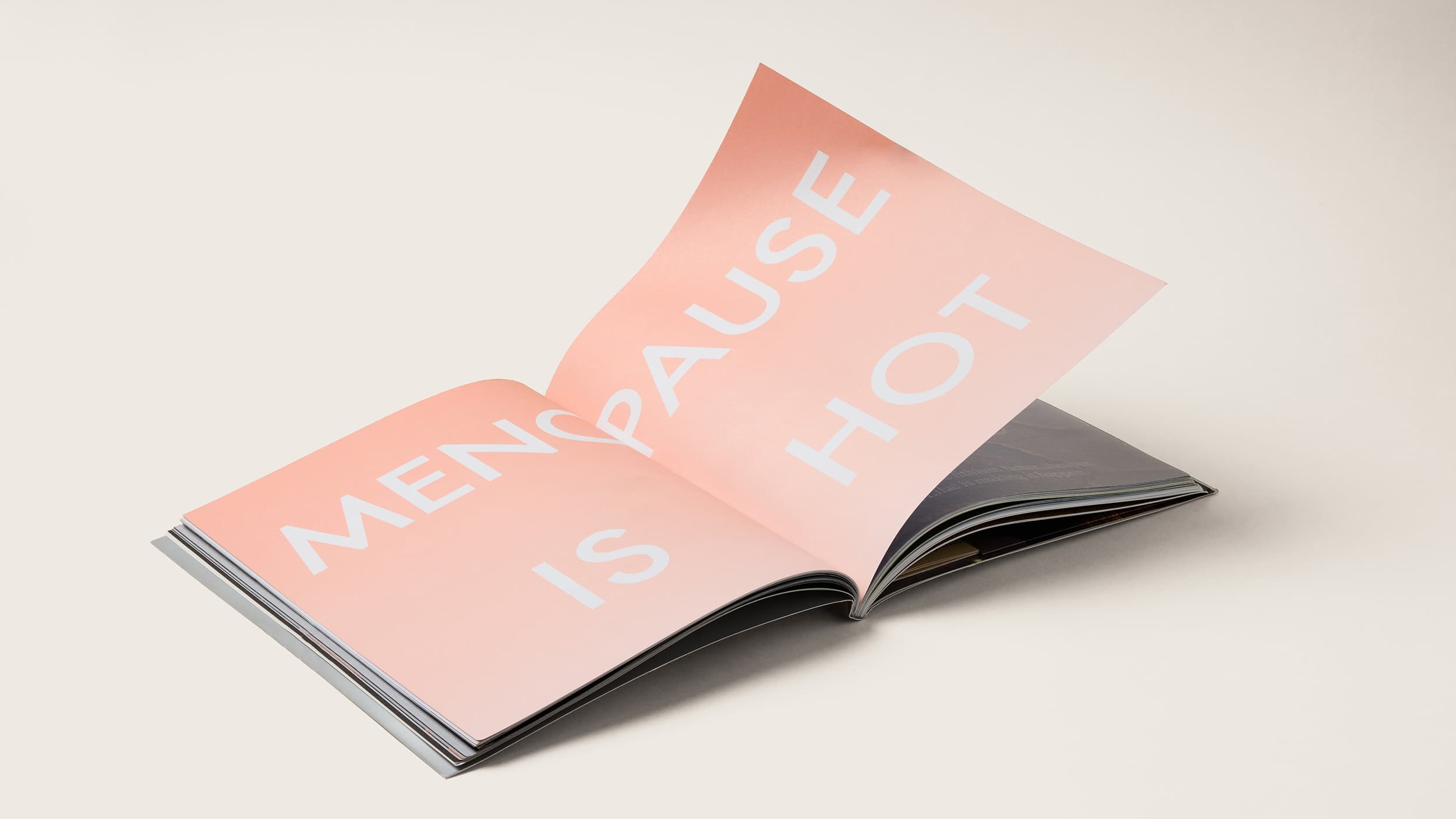 Magazine spread with large words stating Menapause is hot on peach background